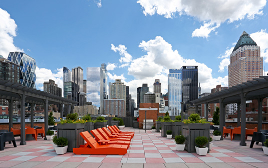 Amenities gallery - 2 of 5 - rooftop at Midwest Court with red lounge chairs